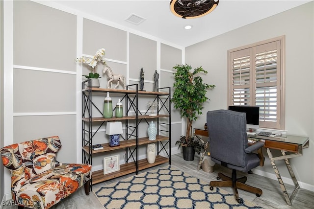 home office with hardwood / wood-style floors