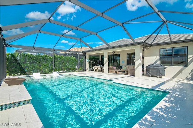 view of pool featuring ceiling fan, a grill, a lanai, and a patio area