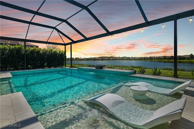 pool at dusk with a lanai and a water view