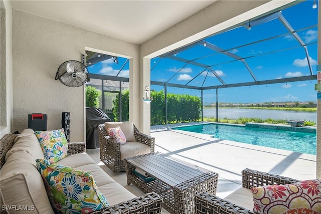 view of pool with a lanai, an outdoor living space, a water view, and a patio