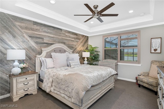 carpeted bedroom featuring a raised ceiling, ceiling fan, and ornamental molding