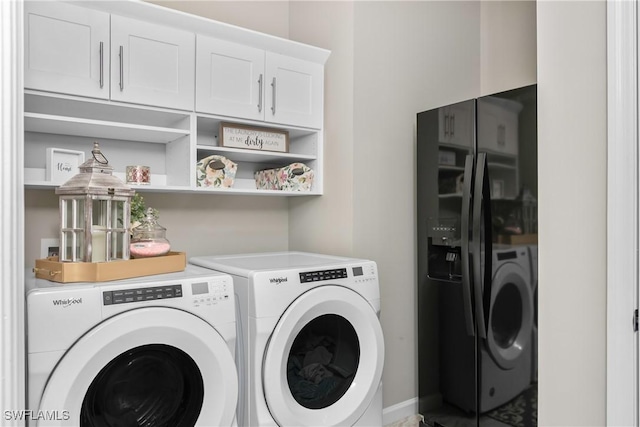 laundry area with cabinets and separate washer and dryer