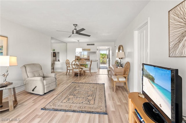 living room featuring ceiling fan and light wood-type flooring