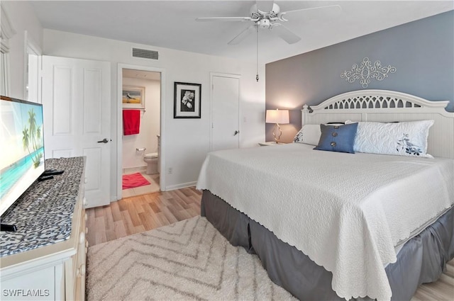 bedroom with ceiling fan, light hardwood / wood-style floors, and ensuite bath