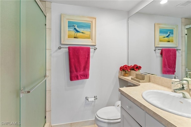 bathroom with tile patterned flooring, vanity, toilet, and a shower with door