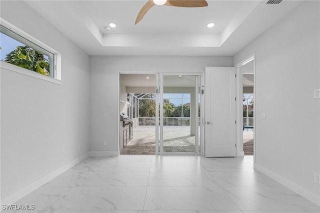 unfurnished room with a tray ceiling and ceiling fan