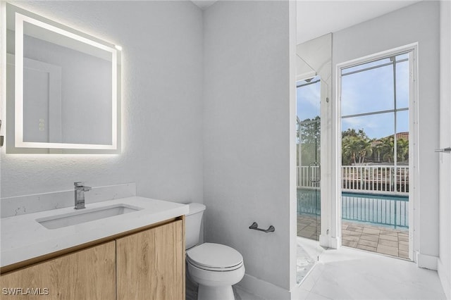 bathroom featuring tile patterned floors, vanity, and toilet