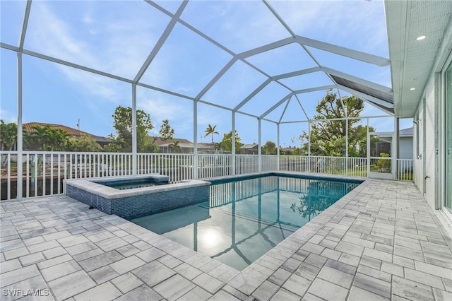 view of swimming pool featuring a lanai, a patio area, and an in ground hot tub