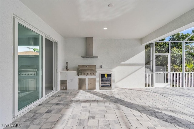 view of patio / terrace with wine cooler, area for grilling, and sink