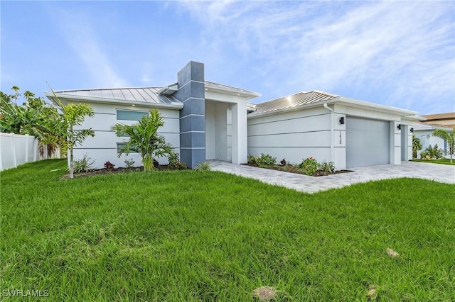 view of front facade with a front yard and a garage