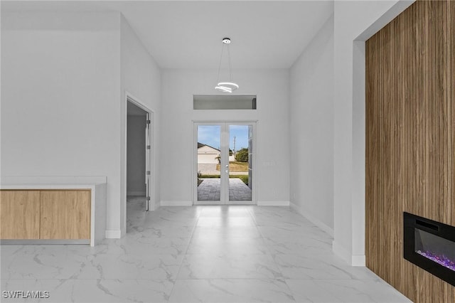 entryway with a large fireplace and wooden walls