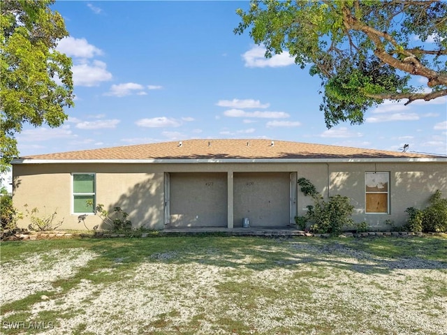 rear view of property with a lawn