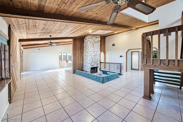 interior space with vaulted ceiling with beams, wooden ceiling, and light tile patterned flooring