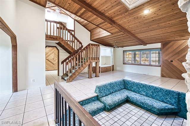 living room featuring tile patterned floors, lofted ceiling with skylight, ceiling fan, and wooden ceiling