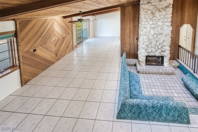 interior space with tile patterned floors, vaulted ceiling with beams, wood walls, and wood ceiling