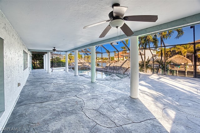 view of patio with ceiling fan and a lanai