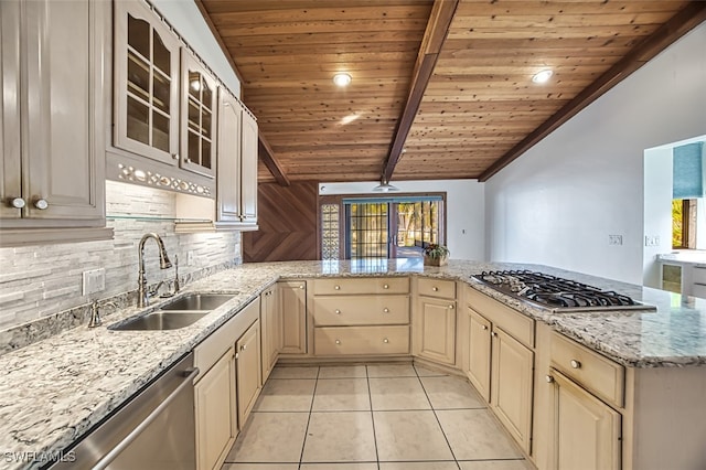 kitchen featuring lofted ceiling with beams, sink, appliances with stainless steel finishes, light tile patterned flooring, and kitchen peninsula