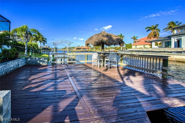 view of dock with a deck with water view