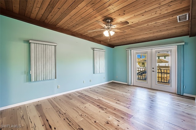 empty room featuring french doors, light wood-type flooring, vaulted ceiling, ceiling fan, and wooden ceiling