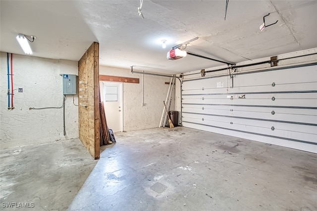 garage with electric panel and a garage door opener