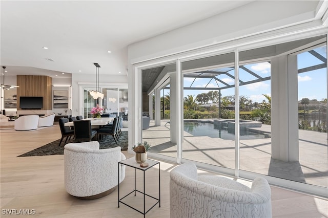 living room with a water view and light hardwood / wood-style floors