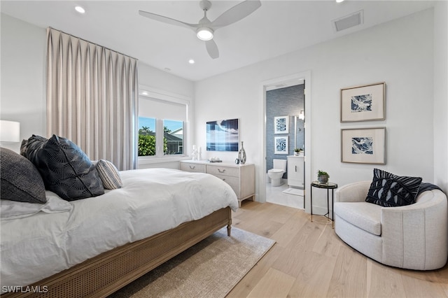 bedroom featuring connected bathroom, light hardwood / wood-style flooring, and ceiling fan