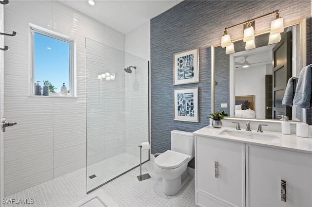 bathroom featuring a tile shower, vanity, tile patterned floors, and ceiling fan