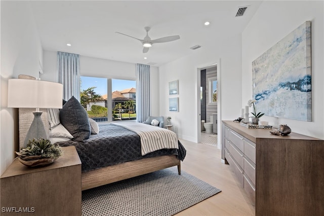 bedroom featuring connected bathroom, ceiling fan, and light hardwood / wood-style flooring