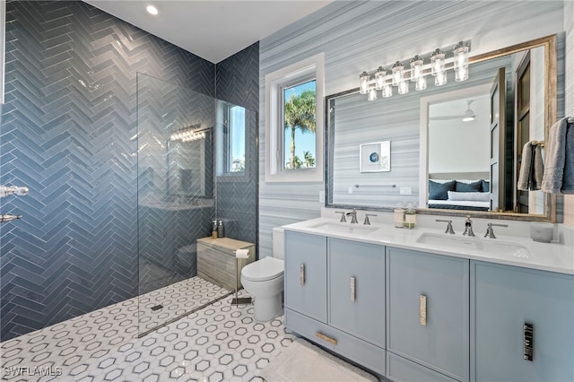 bathroom with vanity, tile patterned floors, ceiling fan, toilet, and tile walls