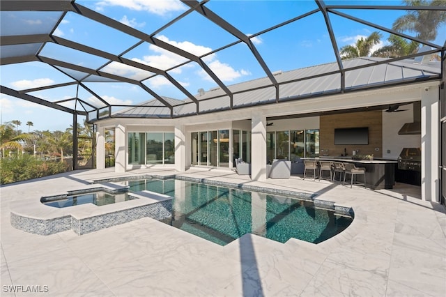 view of swimming pool with exterior kitchen, a lanai, a bar, and an in ground hot tub