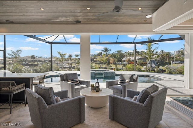 view of patio / terrace featuring ceiling fan, an outdoor living space, and glass enclosure