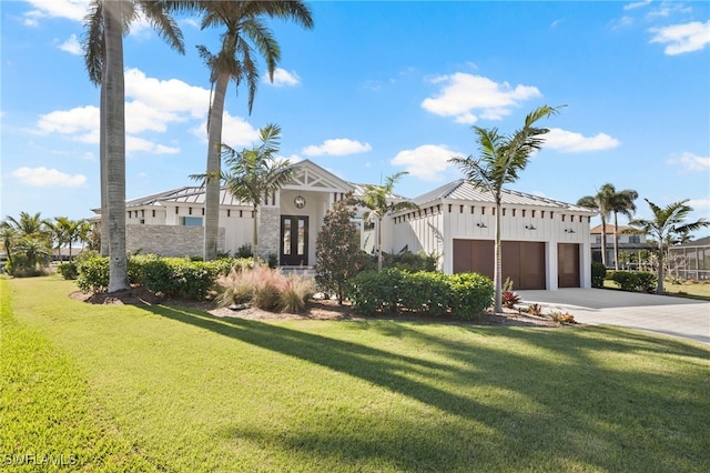 view of front of home with a garage and a front yard