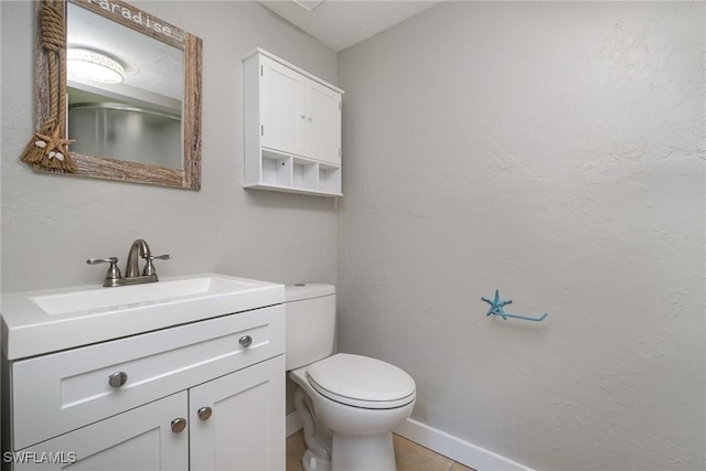 bathroom featuring tile patterned floors, vanity, and toilet