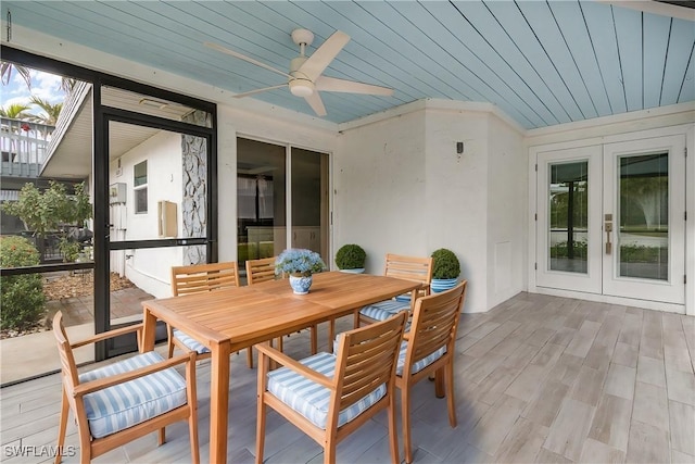 sunroom / solarium with french doors, ceiling fan, and wood ceiling