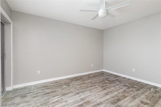 empty room with ceiling fan and hardwood / wood-style flooring