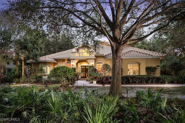 mediterranean / spanish-style home with a balcony