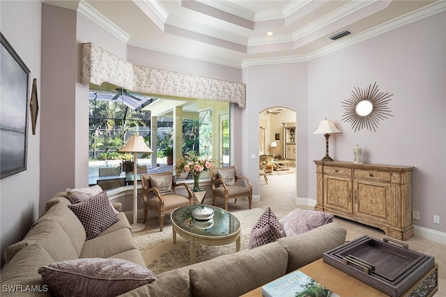 living room with light tile patterned floors and crown molding