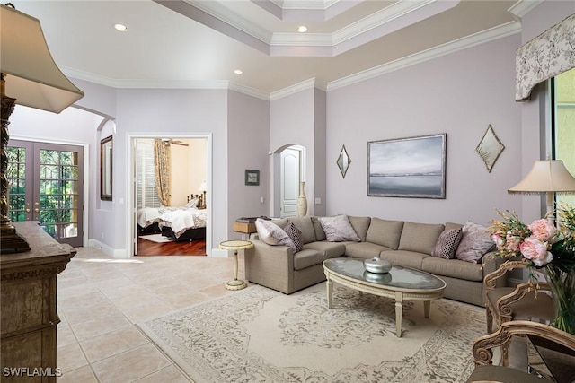 living room featuring light tile patterned floors, crown molding, and french doors