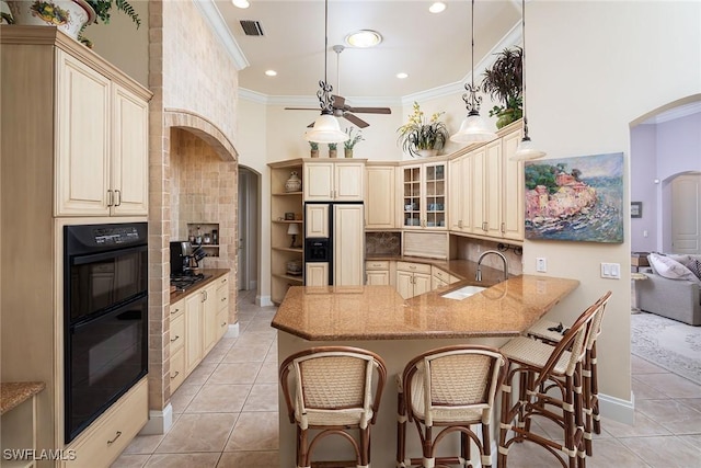 kitchen featuring pendant lighting, sink, light tile patterned floors, double oven, and kitchen peninsula