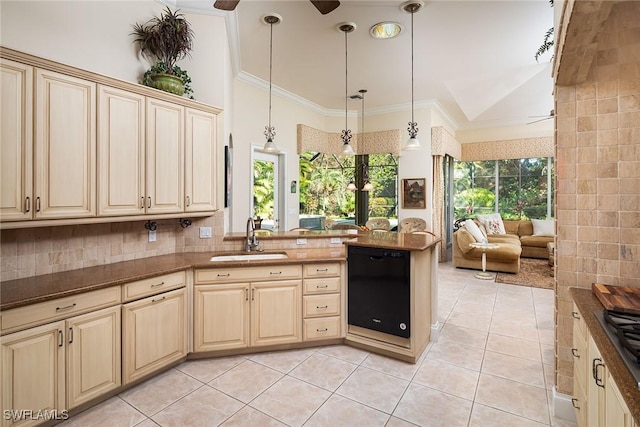 kitchen featuring kitchen peninsula, pendant lighting, plenty of natural light, and sink