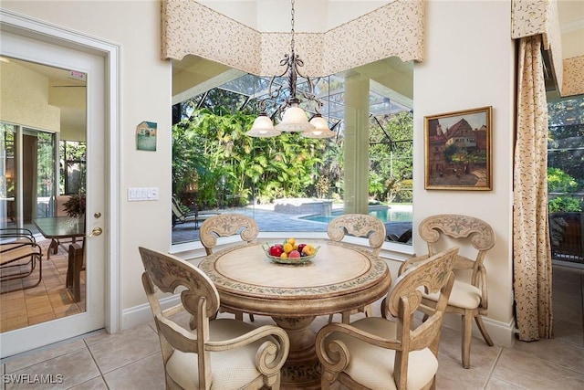 dining area featuring an inviting chandelier and light tile patterned flooring