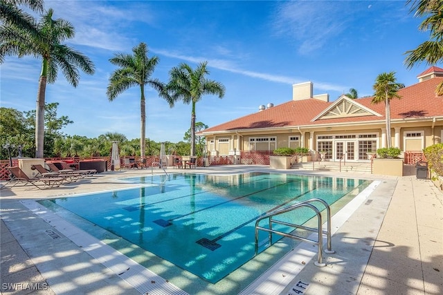 view of pool featuring french doors and a patio