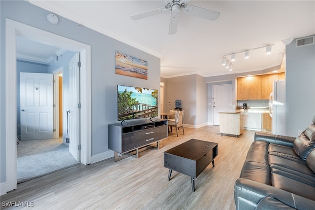 living room with ceiling fan, rail lighting, light hardwood / wood-style floors, and ornamental molding