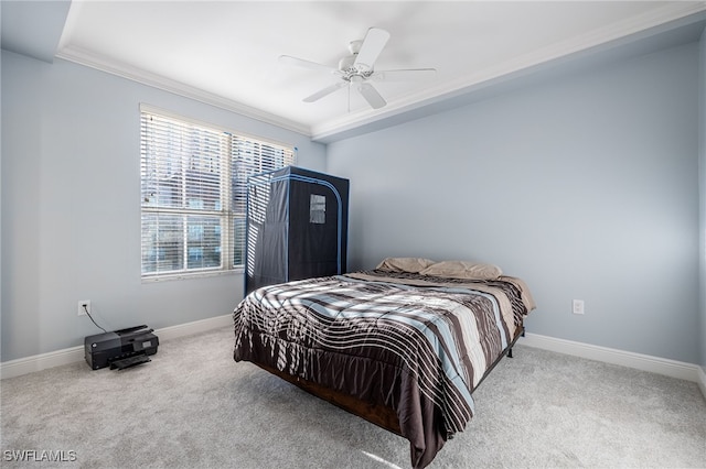 carpeted bedroom with ceiling fan and crown molding