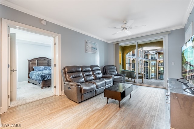 living room featuring crown molding, ceiling fan, and light hardwood / wood-style floors