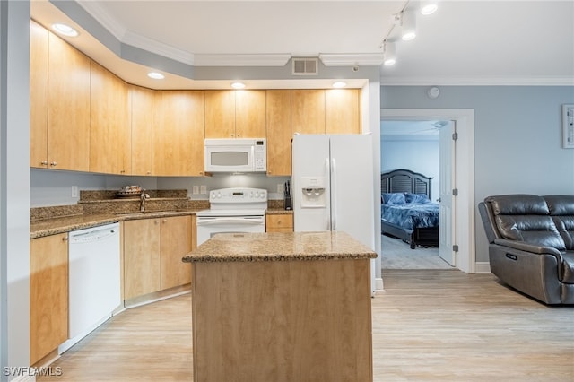 kitchen with a center island, white appliances, stone counters, crown molding, and light wood-type flooring