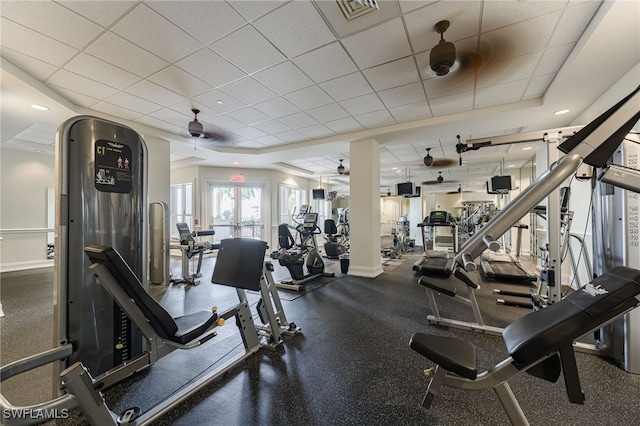 exercise room featuring ceiling fan and a drop ceiling