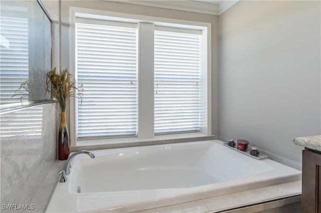 bathroom with plenty of natural light, ornamental molding, and vanity