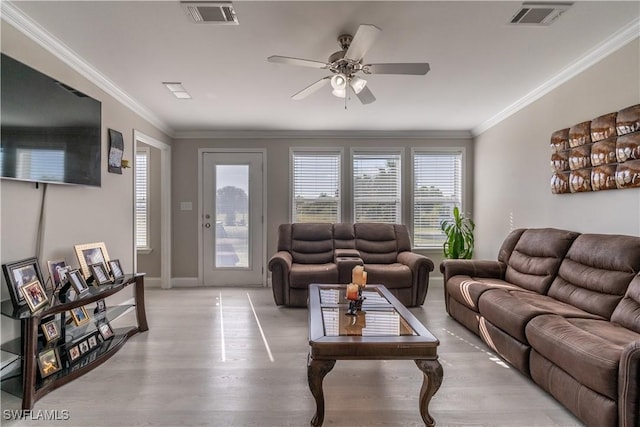 living room with light hardwood / wood-style floors, ceiling fan, and crown molding