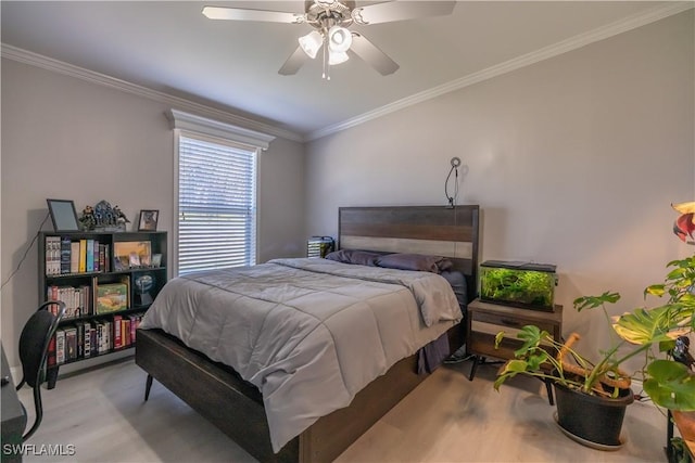 bedroom with ceiling fan, crown molding, and light hardwood / wood-style flooring